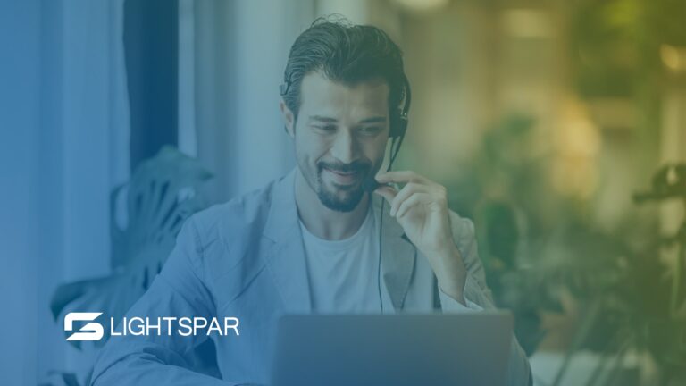 Team member using headset with laptop, representing a reliable business phone system by Lightspar.