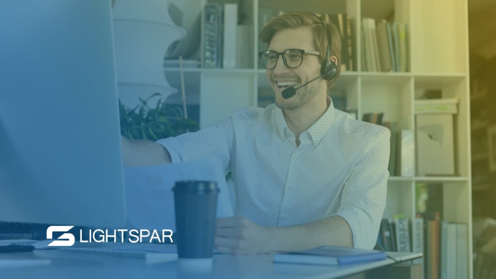 A person using a VoIP phone system in an office, looking pleased because it doesn't have poor call quality.